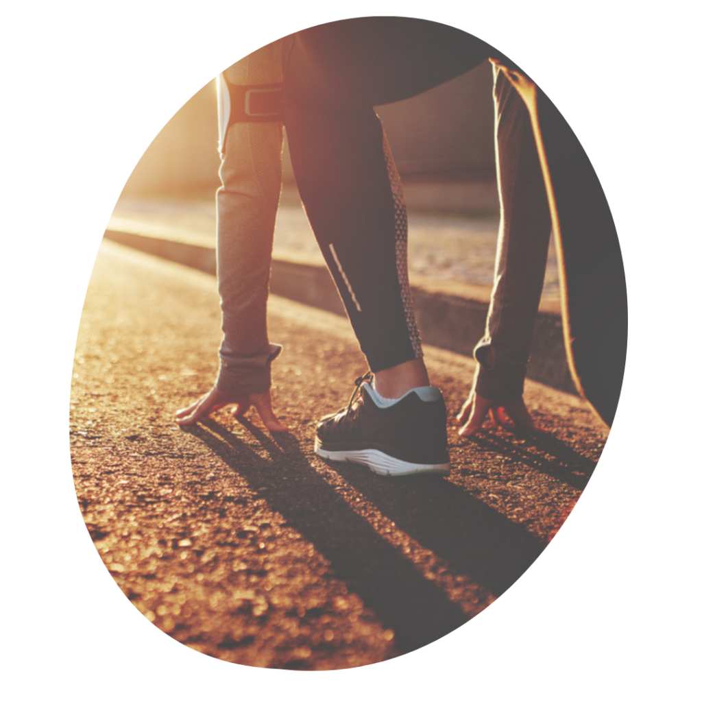 Picture of a runner's hands and feet kneeling to start a race.