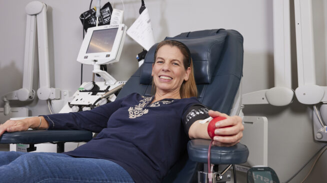 Blood donor smiling while giving blood