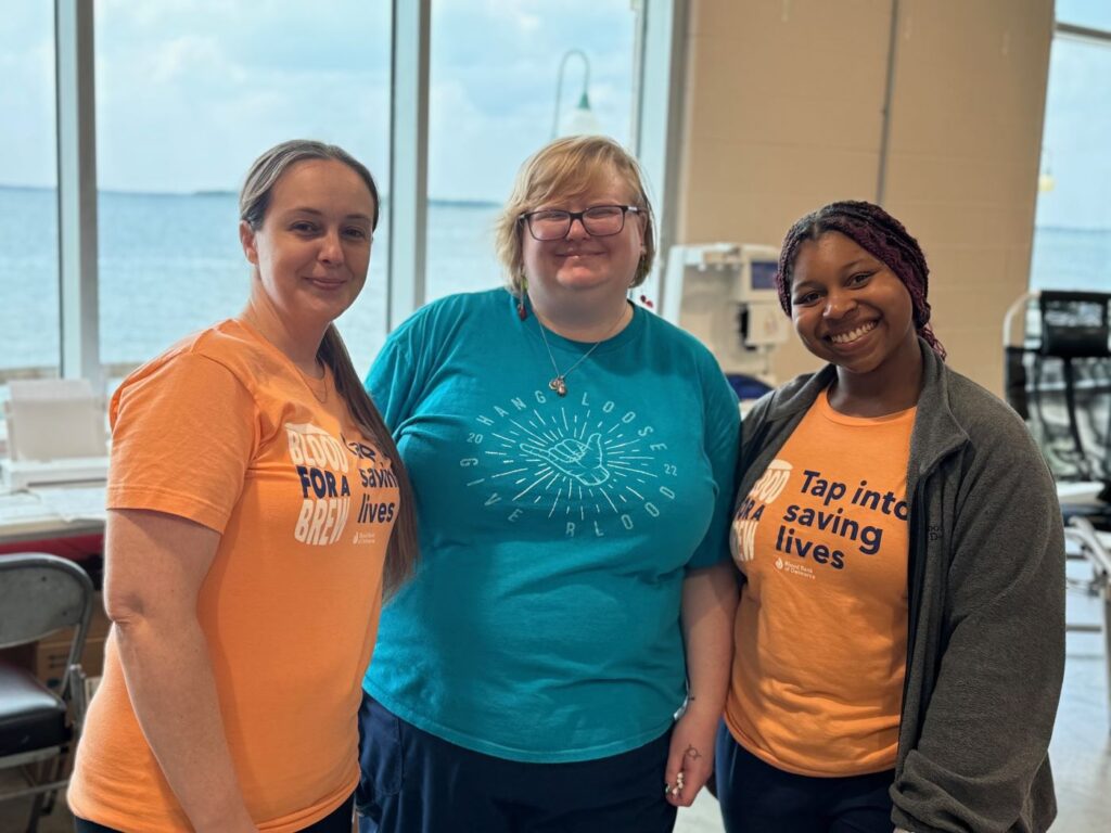 Three smiling blood donors.