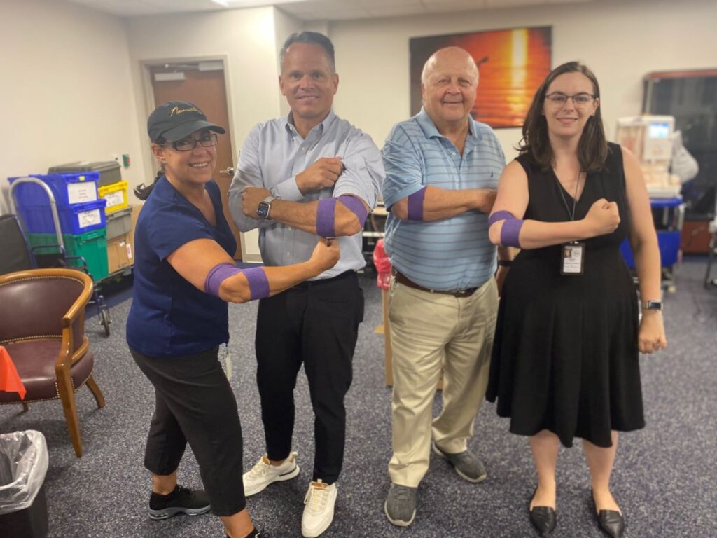 Four smiling blood donors.